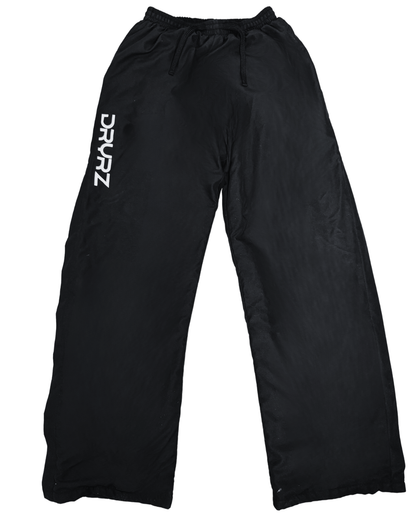Flat lay of zipped DRYRZ BambooLayer thermal joggers for post-workout with elastic waistband and open cuff design. White logo detail on DRYRZ recovery sweatpants, enhancing performance-driven branding for active and rest-day wear.
